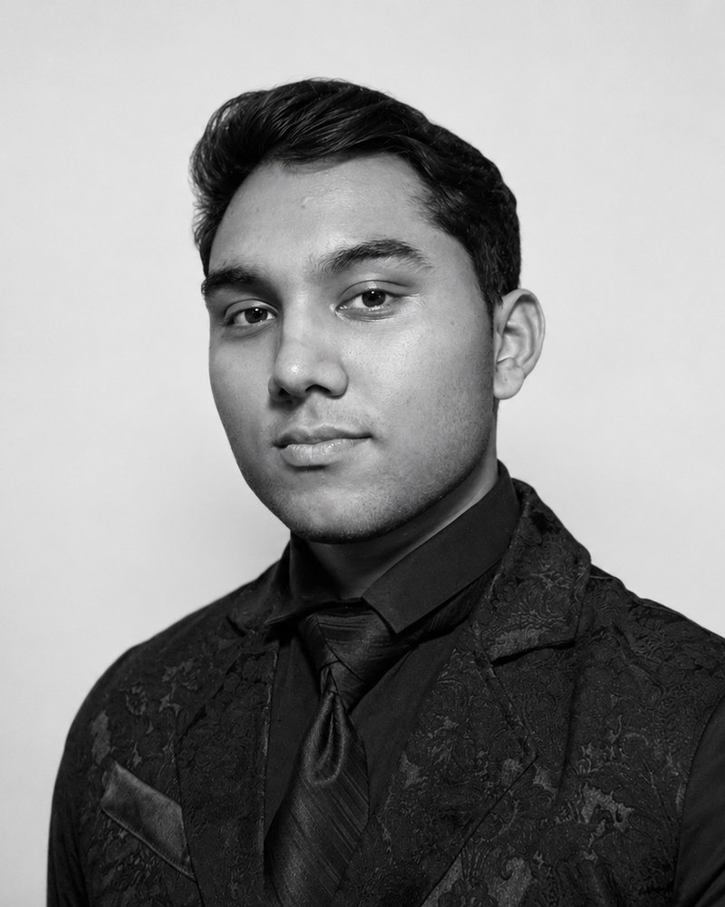 Black and white head-and-shoulders portrait of Senaajit Raghu